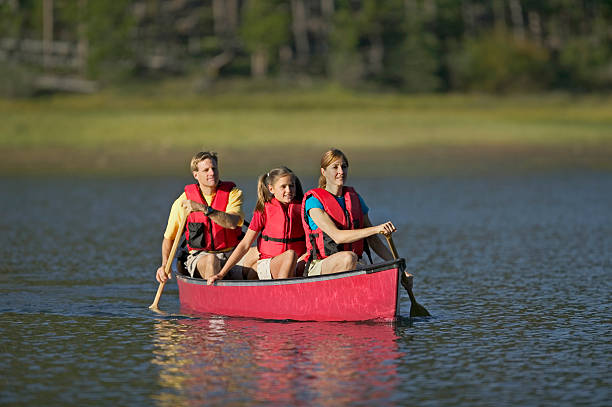 istock Family Canoeing on Mountain Lake 115939970