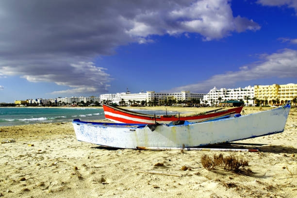 Sandy beach in Hammamet with lots of traditional fishing boat.Tunisia