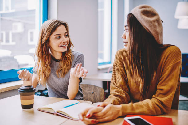 istock Tow happy successful female students discussing excited ideas for startup project, young multicultural hipster girls consultancy to each other about course work,concept of communication and education 1159401629