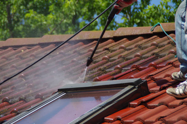 istock House roof cleaning with pressure tool 1159405884