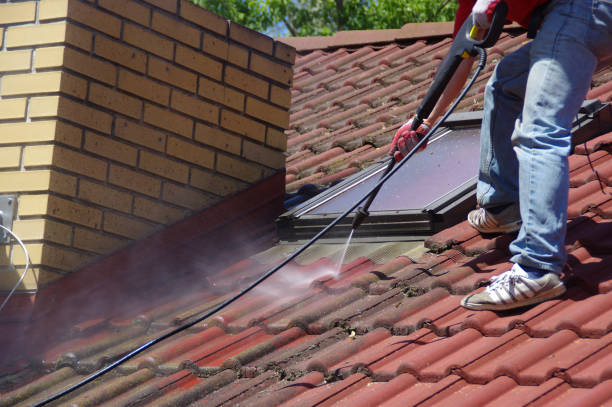 istock House roof cleaning with pressure tool 1159405972