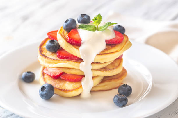 Portion of ricotta fritters with fresh berries stock photo