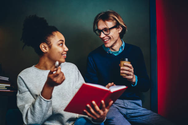 istock Happy diversity friends talking to each other discussing ideas written in notepad on free time, cheerful multiracial male and female colleagues communicating about common project enjoying conversation 1159407166