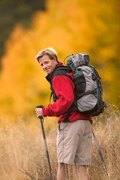 Backpacker Looking Back at Camera in Fall stock photo