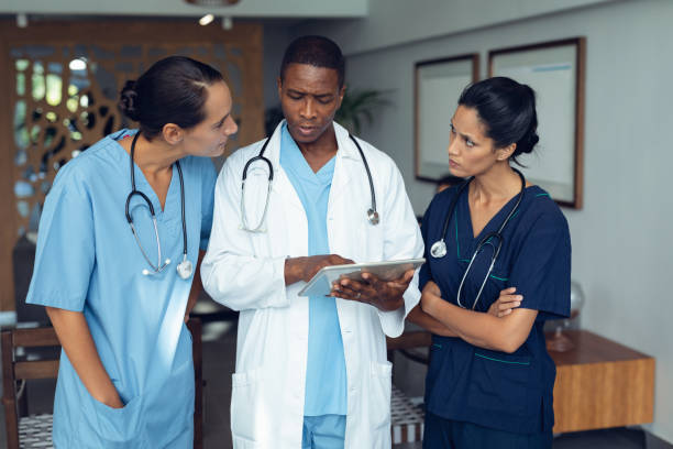 istock Doctors discussing over digital tablet in the hospital 1159412247