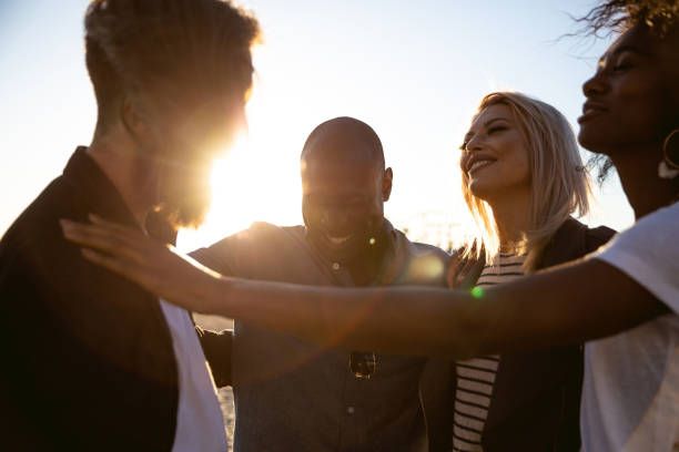 istock Friends enjoying a beautiful summer on the beach 1159412530