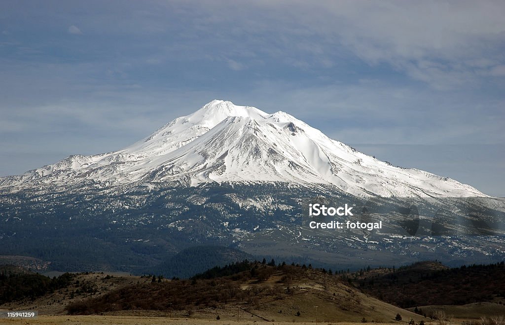 Mt. Shasta Mt. Shasta in northern California, an extinct volcano, looms above the surrounding countryside Awe Stock Photo