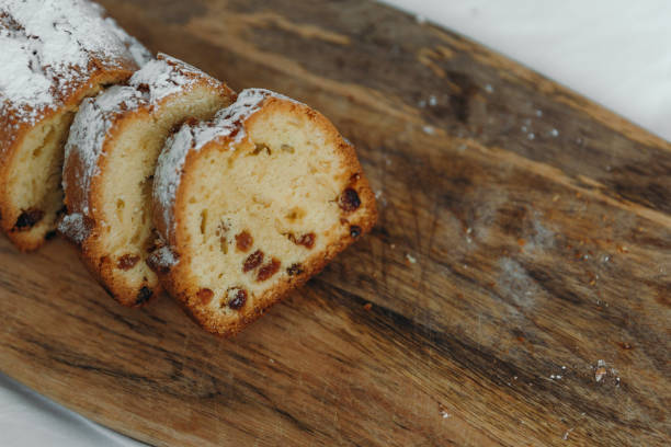 istock Raisin cake, dusted with icing sugar. Cupcake with raisins on a wooden board. 1159412687