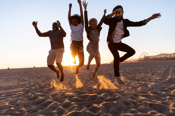 istock Happy friends on the beach 1159412920