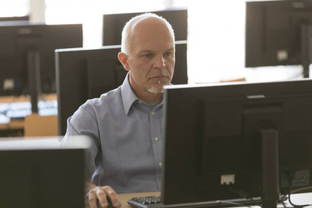 istock Dedicated senior businessman working at a desktop 1159413979