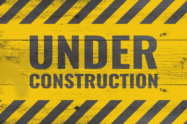 istock under construction warning message painted on aged wooden planks 1159414336