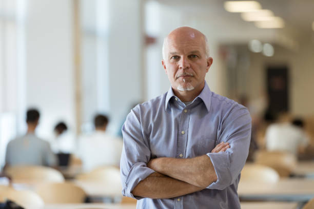 istock Resolute businessman standing with folded arms 1159414372