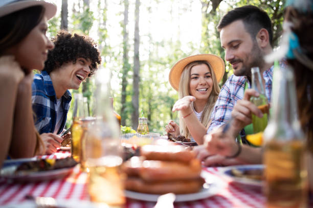 istock Friends having a barbecue party in nature while having fun 1159414857