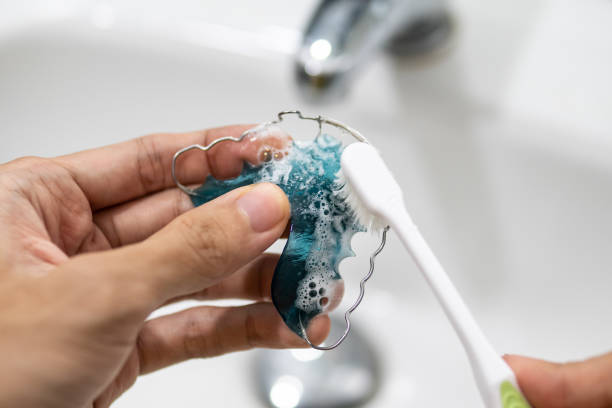 cleaning retainer with toothbrush stock photo