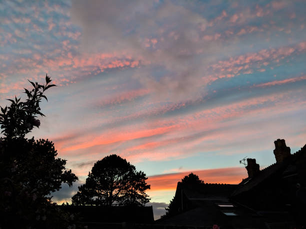 istock Orange and blue sky sunset. Silhouettes below. 1159416347