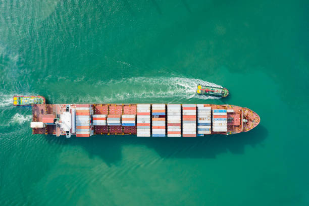 istock Aerial view and top view. Container ship in pier with crane bridge carries out export  and import business in the open sea. Logistics and transportation 1159416709