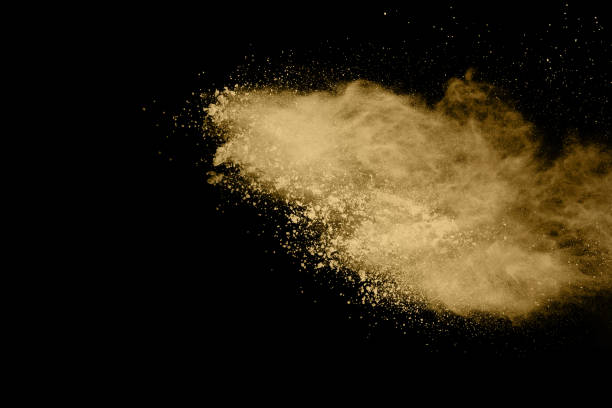 istock Golden powder explosion on black background. Freeze motion. 1159418178