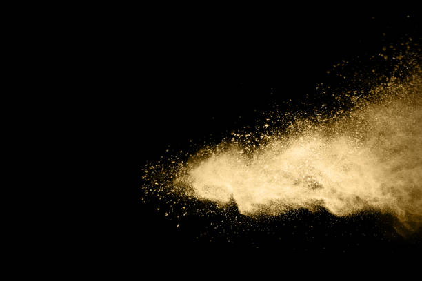istock Golden powder explosion on black background. Freeze motion. 1159418183