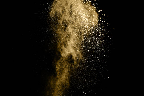istock Golden powder explosion on black background. Freeze motion. 1159418186