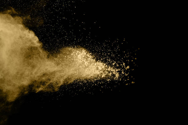 istock Golden powder explosion on black background. Freeze motion. 1159418199