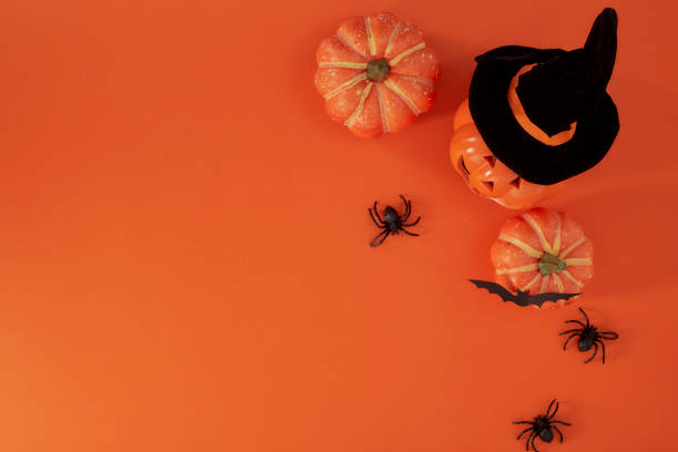 istock Pumpkins decorations on orange paper background. Halloween concept 1159418398