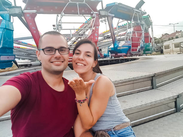 istock Couple making selfie in amusement park 1159419296