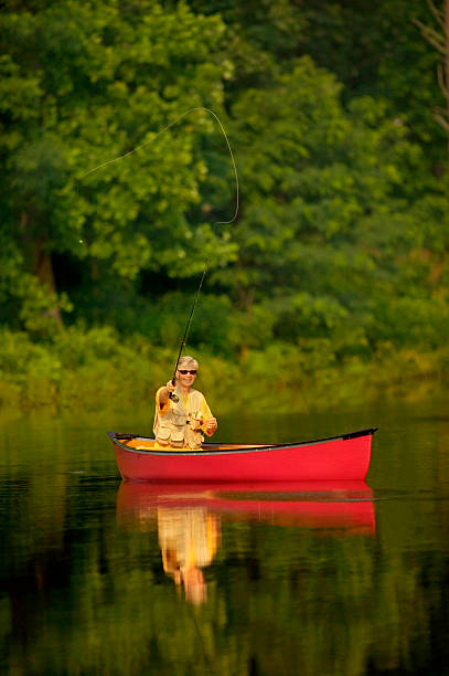 istock Senior Man Fly Fishing From Canoe 115942250