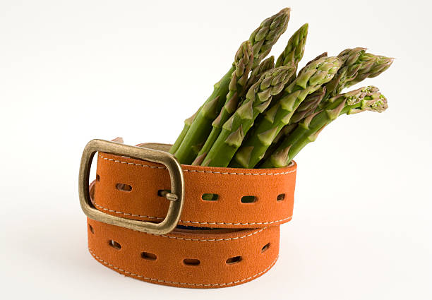 Asparagus and a belt stock photo
