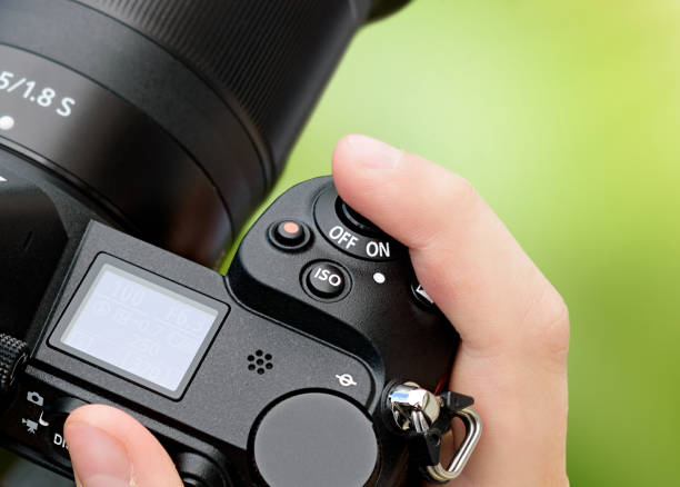 istock Hand holds SLR camera close-up 1159424990
