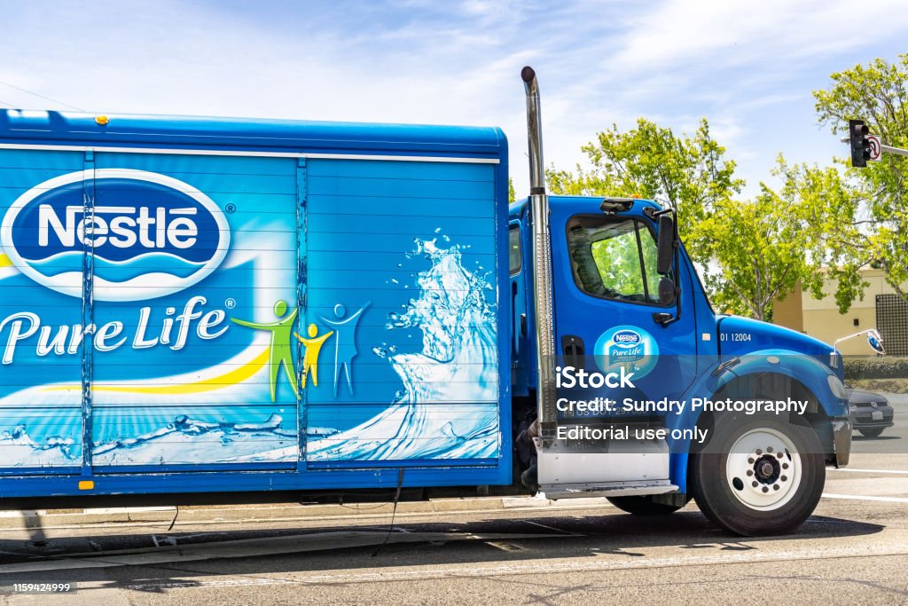 Nestle branded truck travelling on a street June 25, 2019 Sunnyvale / CA / USA - Nestle branded truck travelling through a city in south San Francisco bay area Nestle Stock Photo