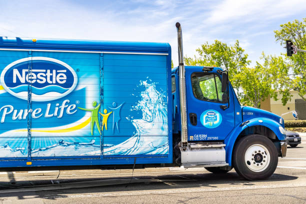 Nestle branded truck travelling on a street June 25, 2019 Sunnyvale / CA / USA - Nestle branded truck travelling through a city in south San Francisco bay area san francisco bay area built structure street city street stock pictures, royalty-free photos & images