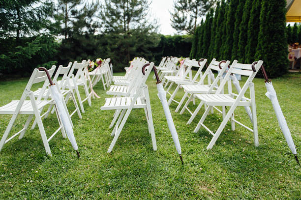 istock Outgoing wedding ceremony. Decor Studio. white wooden chairs on a green lawn. 1159426919
