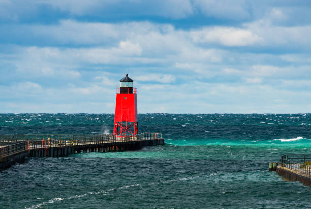Charlevoix South Pierhead Lighthouse The Charlevoix South Pierhead Lighthouse against a dramatic sky. charlevoix photos stock pictures, royalty-free photos & images