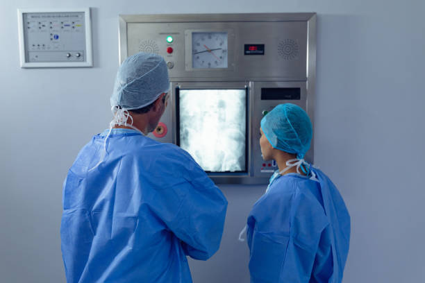 istock Surgeons examining x ray on x-ray light box at hospital 1159427379