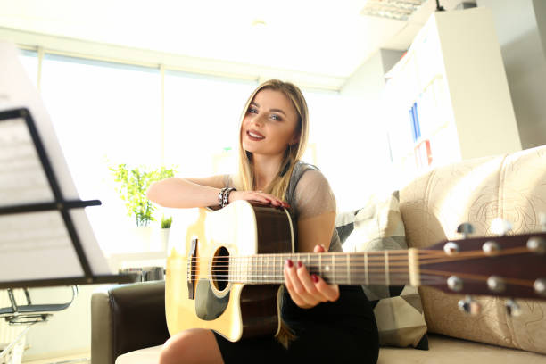 istock Beautiful Guitarist Creating Musical Composition 1159427505
