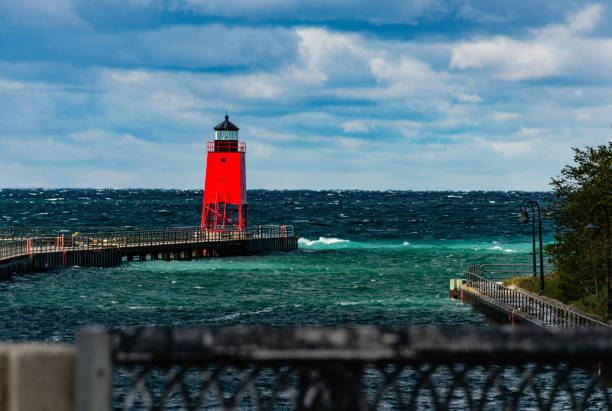 Charlevoix South Pierhead Lighthouse The Charlevoix South Pierhead Lighthouse against a dramatic sky. charlevoix photos stock pictures, royalty-free photos & images