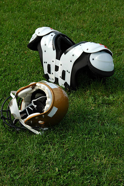 istock futball helmet in the grass 115942796