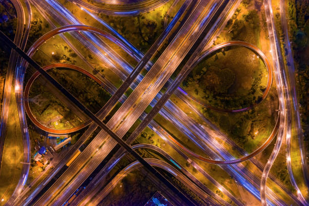 istock Aerial view of highway junctions. Bridge roads shape number 8 or infinity sign in structure of architecture concept. Top view. Urban city, Bangkok at night, Thailand. 1159428683