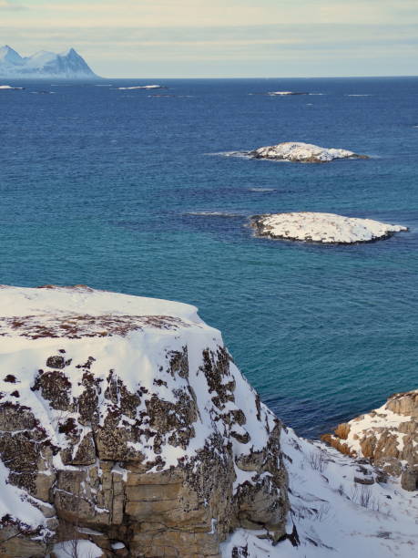 norwegian sea near Sommaroy with snowy islands On the island of Sommaroya, Troms County, Norway sommaroy stock pictures, royalty-free photos & images
