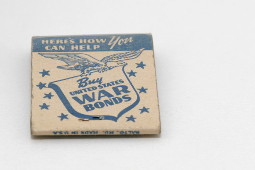 A close up of a matchbook from World war II era, advertising war bonds