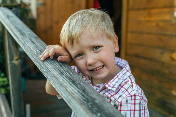 istock Cute boy on the steps of his house 1159431010