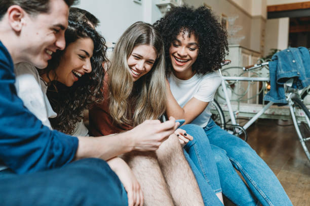 istock Friends looking at a mobile phone together 1159432121