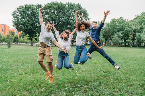 Friends jumping together at the park