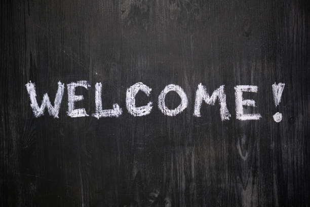 istock Welcome sign handwritten on black background. 1159432247