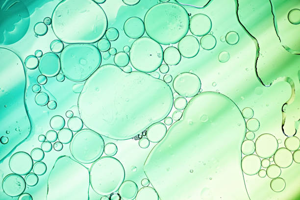 istock Light blue and green oil bubbles in water with abstract pattern 1159432869
