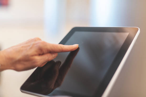 istock Corporate People Using Digital Tablet Technology Mature Adult in Corporate Office Space in Western Colorado 1159434530