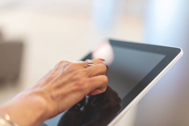 istock Corporate People Using Digital Tablet Technology Mature Adult in Corporate Office Space in Western Colorado 1159434567