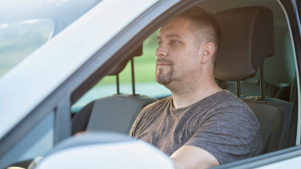 istock Mid adult man driving his car 1159437001