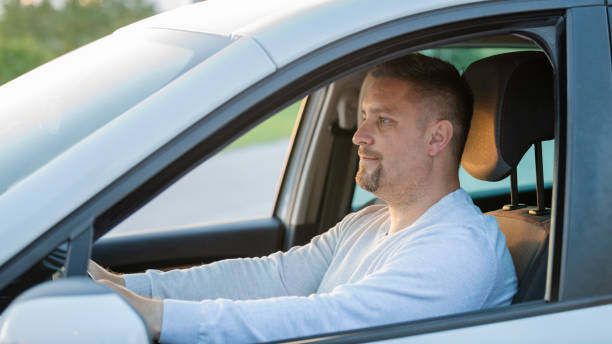 istock Mid adult man driving his car 1159437268