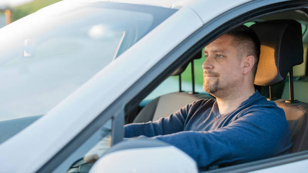 istock Mid adult man driving his car 1159437884
